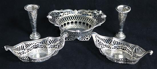 An Edwardian pierced silver oval dish, a pair of smaller silver dishes and a pair of silver posy vases.